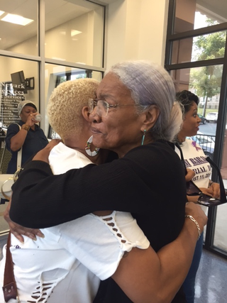 Stacie Hillsman, left, hugs Amina Baraka, mother of Mayor Ras Baraka and Shani Baraka (Angela Helm/The Root)